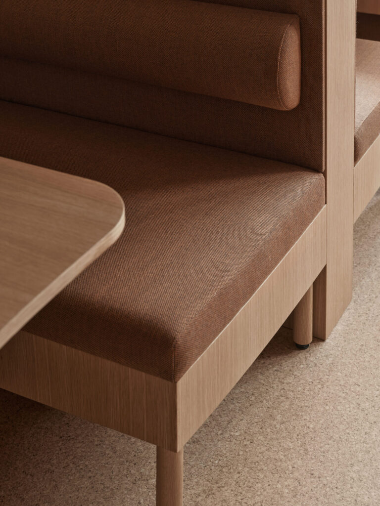 close up to a office sofa upholstery and oak table
