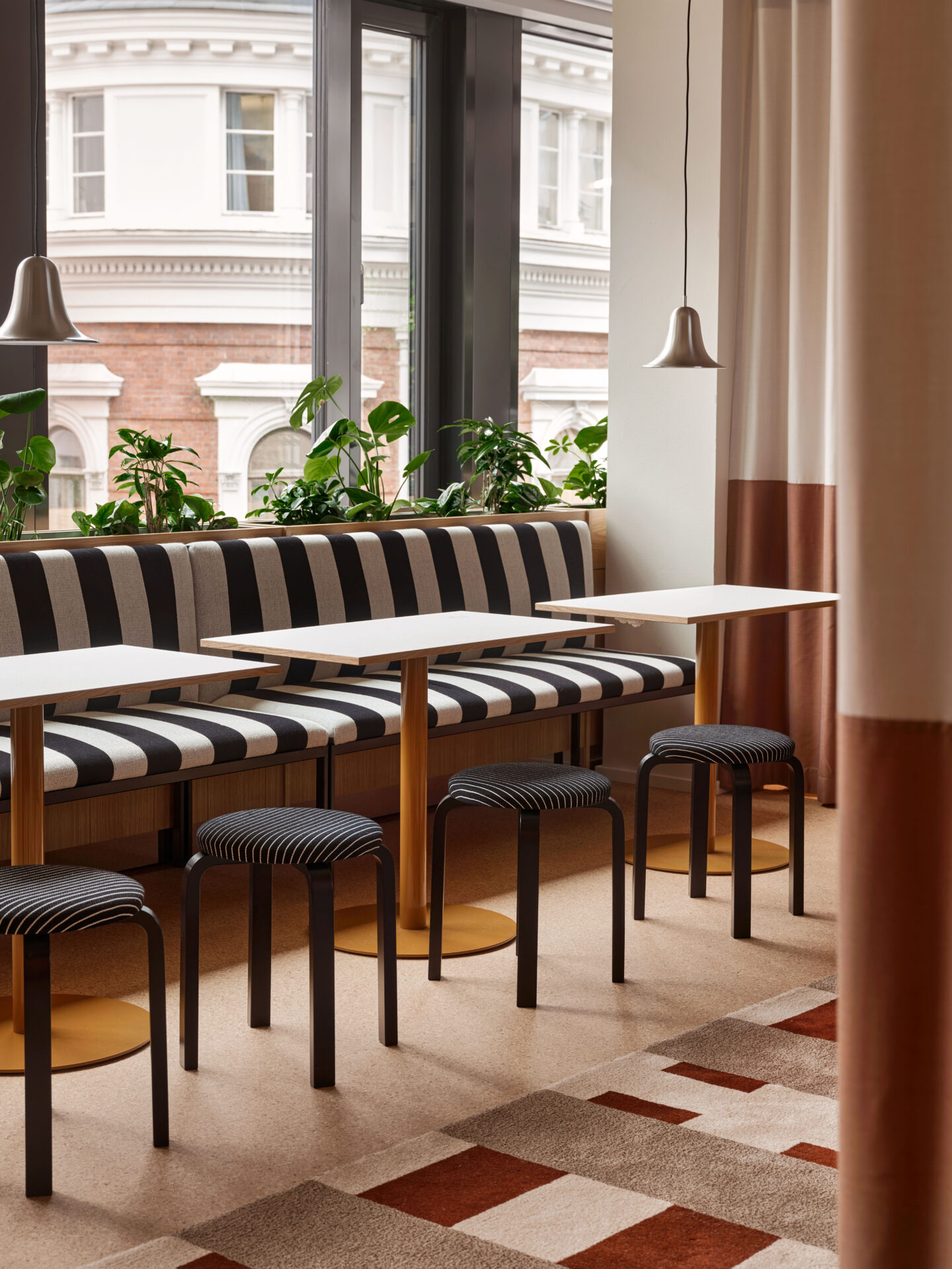 black and white striped sofa, square tables, artek black stools, colorful carpet, modern office design