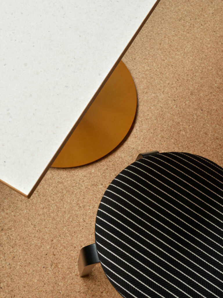 close up of an artek stool and a table