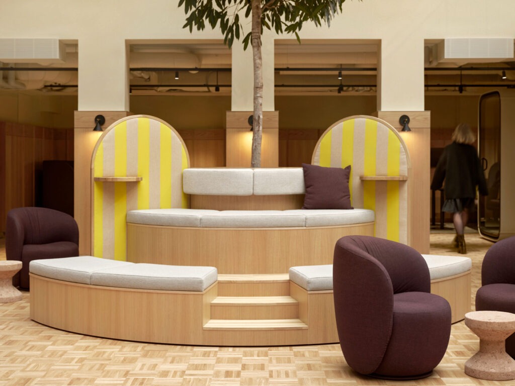 custom made seating furniture with a tree planted in the middle, oak surfaces, burgundy armchairs