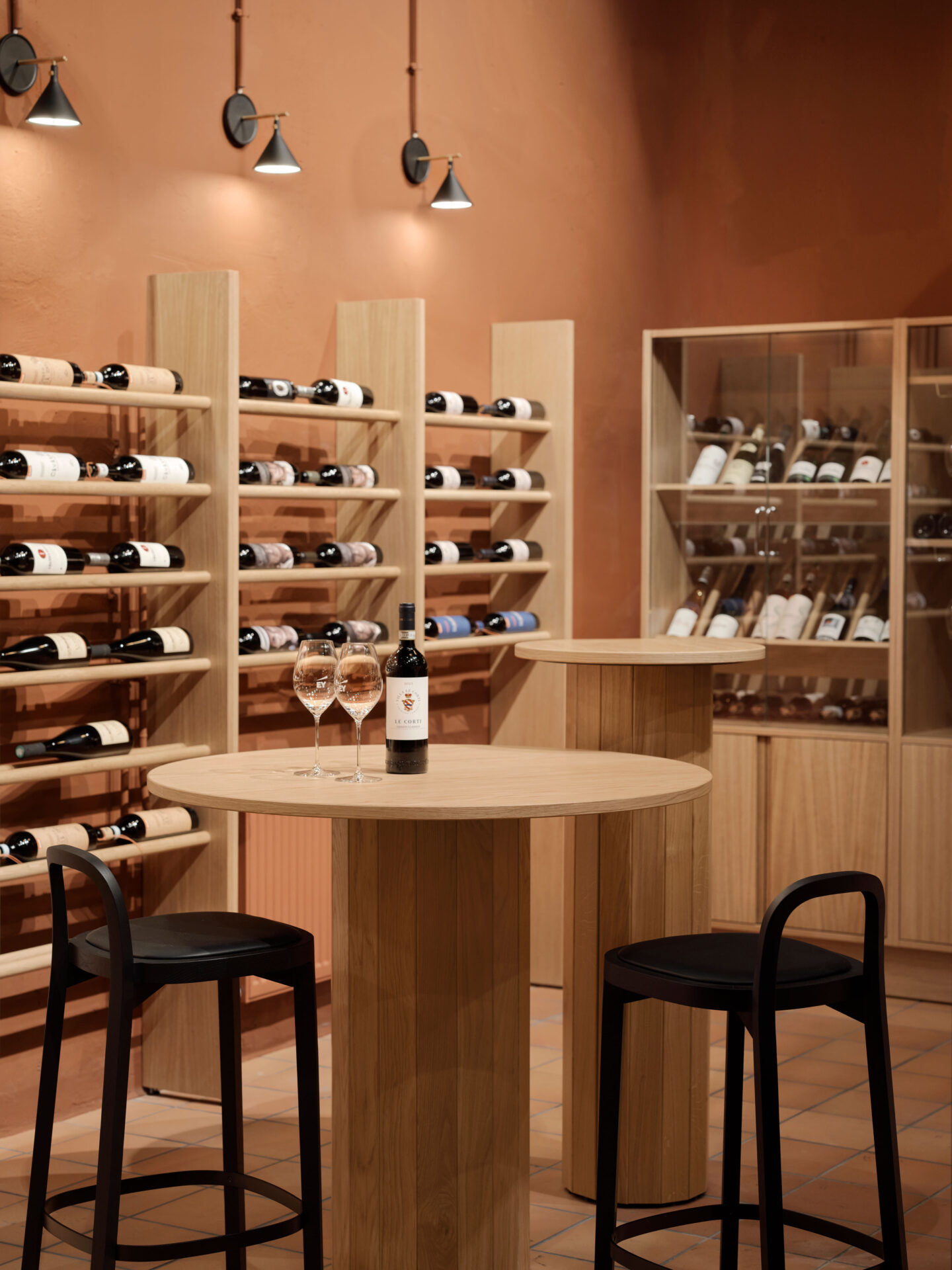 modern wine storage room, round oak table and two elegant bar black chair in front